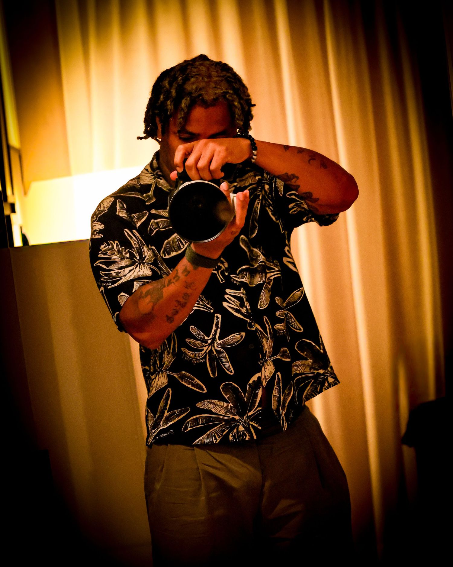 Ritchie photographing with a long lens in warm light